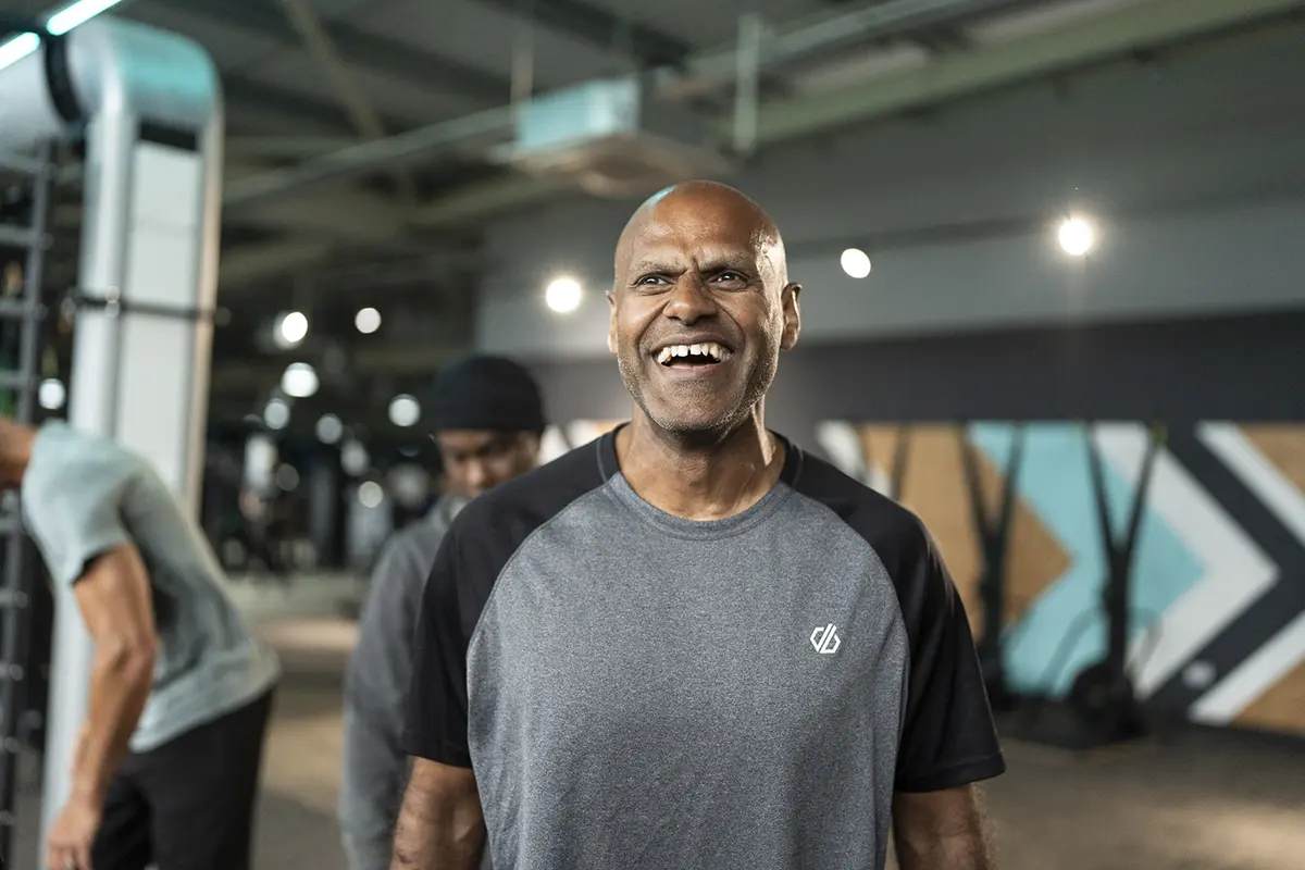 Man smiles as he looks slightly above camera